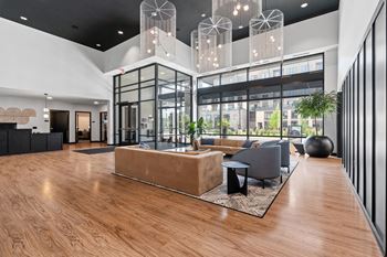a large lobby with couches and chairs and large windows